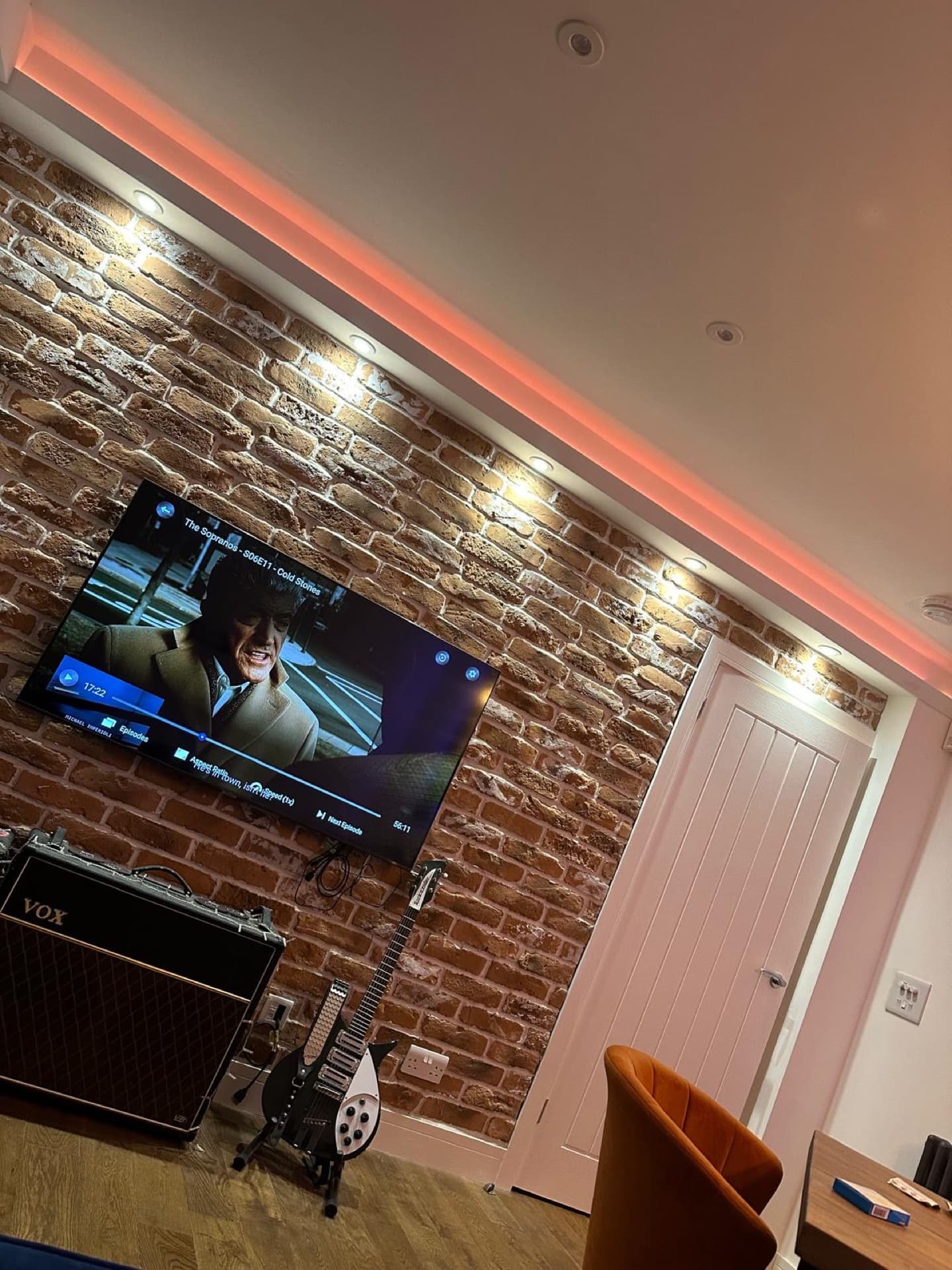 Warm decorative pendant lighting over brick wall in residential interior