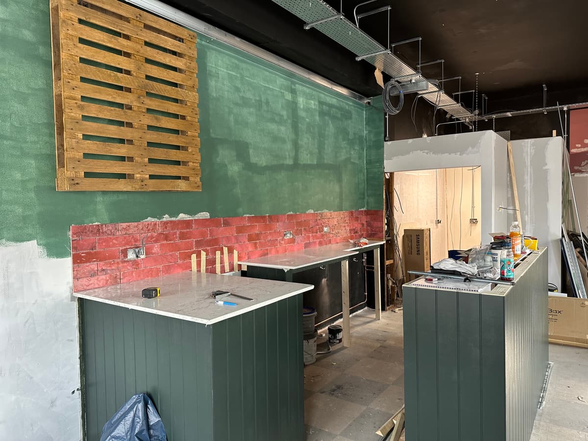 Counter units and tiled splashback being fitted