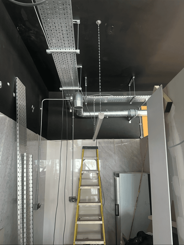 Ceiling containment and ductwork installed above the shop floor